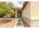 Inviting front porch with sitting area, iron gate, and walkway to the home's entrance at 14205 N 136Th Ln, Surprise, AZ 85379
