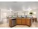 Functional kitchen with eat-in breakfast bar featuring stainless steel appliances and ample cabinetry at 14205 N 136Th Ln, Surprise, AZ 85379