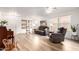 Bright living room with hardwood floors, neutral paint, and abundant natural light at 14205 N 136Th Ln, Surprise, AZ 85379