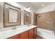 Rustic designed bathroom features a double vanity, stylish lighting, bathtub and tiled shower at 14916 W Georgia Dr, Surprise, AZ 85379