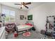 Cozy bedroom featuring a ceiling fan, window with blinds, carpet floors and eclectic decor at 14916 W Georgia Dr, Surprise, AZ 85379