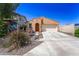 Exterior view of a single-Gathering home with neutral stucco, a two-car garage, and low-maintenance desert landscaping at 14916 W Georgia Dr, Surprise, AZ 85379