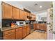 Well-appointed kitchen with stainless steel appliances, wood cabinetry and tile flooring at 14916 W Georgia Dr, Surprise, AZ 85379