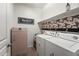 Convenient laundry room with appliances, storage, and a stylish design at 14916 W Georgia Dr, Surprise, AZ 85379