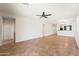 Open floorplan living room with tile floors, neutral walls, and open view of the kitchen and hallway at 14916 W Georgia Dr, Surprise, AZ 85379