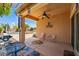 Charming covered patio with ceiling fan, outdoor seating, and a view of the beautiful pool at 14916 W Georgia Dr, Surprise, AZ 85379