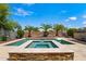Backyard oasis featuring a sparkling pool, spa, and lush landscaping, perfect for relaxing and entertaining at 14916 W Georgia Dr, Surprise, AZ 85379