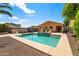 Inviting pool area with waterfall feature, deck, lounge chairs, and well-maintained landscaping at 14916 W Georgia Dr, Surprise, AZ 85379
