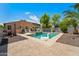 Lush backyard with a stunning pool, lounging chairs, mature landscaping, and a relaxing atmosphere at 14916 W Georgia Dr, Surprise, AZ 85379