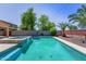 Refreshing pool and spa with waterfall feature nestled in a private, tree-lined backyard at 14916 W Georgia Dr, Surprise, AZ 85379