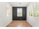 An empty room with white walls, a dark accent wall, and plenty of natural light at 14916 W Georgia Dr, Surprise, AZ 85379