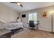 Cozy bedroom featuring a ceiling fan, a workspace near the window, and neutral-toned decor for a warm, inviting atmosphere at 1601 N Saba St # 308, Chandler, AZ 85225