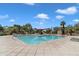 Community pool with shade coverings and landscaping at 1601 N Saba St # 308, Chandler, AZ 85225