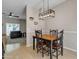 Bright dining room with modern lighting, wood table, and easy access to living area at 1601 N Saba St # 308, Chandler, AZ 85225