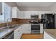 Updated kitchen features stainless steel appliances, granite countertops and backsplash, and ample cabinet space at 1601 N Saba St # 308, Chandler, AZ 85225
