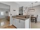 Eat-in kitchen with granite countertops, white cabinets, stainless appliances, and views to the dining room and living area at 1601 N Saba St # 308, Chandler, AZ 85225
