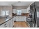 Updated kitchen features stainless steel appliances, granite countertops, white cabinetry and plenty of natural light at 1601 N Saba St # 308, Chandler, AZ 85225
