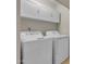 Laundry room featuring a white washer and dryer, with upper white cabinets at 1601 N Saba St # 308, Chandler, AZ 85225