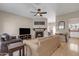 Cozy living room featuring a stone fireplace, wood floors, and a ceiling fan at 1601 N Saba St # 308, Chandler, AZ 85225