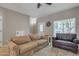Comfortable living room with a large window, hardwood floors, and a cozy seating area at 1601 N Saba St # 308, Chandler, AZ 85225