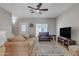Spacious living room featuring hardwood floors, comfortable seating, and a television at 1601 N Saba St # 308, Chandler, AZ 85225