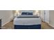 This bedroom features a king bed with a white headboard and stylish lamps on matching white nightstands at 1601 N Saba St # 308, Chandler, AZ 85225