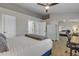Spacious primary bedroom with plush carpet, a ceiling fan, a king bed, and mirrored closet doors at 1601 N Saba St # 308, Chandler, AZ 85225