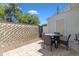 Outdoor patio featuring a table and chairs with a view of a wall and back door at 1601 N Saba St # 308, Chandler, AZ 85225