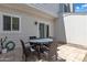 Outdoor patio featuring a table and chairs with a sliding glass door and a partial view of a wall at 1601 N Saba St # 308, Chandler, AZ 85225