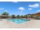 Community pool with clear, inviting water surrounded by lounge chairs and shaded areas at 1601 N Saba St # 308, Chandler, AZ 85225
