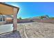 Backyard showing an empty yard with a brick border, a privacy wall and covered patio, ready to be customized at 16112 W Durango St, Goodyear, AZ 85338