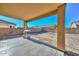 Backyard featuring a covered patio, BBQ grill, and a block wall, ready for landscaping at 16112 W Durango St, Goodyear, AZ 85338