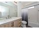 Bathroom featuring vanity with drawers, toilet, and shower-tub combo at 16112 W Durango St, Goodyear, AZ 85338