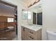 Bathroom featuring a new vanity, sink, and mirror. An entryway is partially visible at 16112 W Durango St, Goodyear, AZ 85338