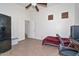 Bedroom with tile floor, ceiling fan, and desk at 16112 W Durango St, Goodyear, AZ 85338