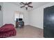 Bedroom with tile floor, ceiling fan, desk, and computer at 16112 W Durango St, Goodyear, AZ 85338