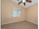 Bedroom with tile flooring, standard ceiling fan, neutral colored walls and ample natural light at 16112 W Durango St, Goodyear, AZ 85338