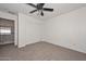 Bedroom featuring carpet flooring, a ceiling fan, and a closet at 16112 W Durango St, Goodyear, AZ 85338