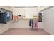 Walk-in closet with shelving and hanging space, providing ample storage solutions at 16112 W Durango St, Goodyear, AZ 85338