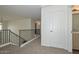 Upstairs hallway with carpet, railing and doorway to bathroom at 16112 W Durango St, Goodyear, AZ 85338