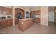 Modern kitchen with an island, wood cabinetry, and stainless steel refrigerator at 16112 W Durango St, Goodyear, AZ 85338