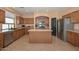 Traditional style kitchen featuring wood cabinets, stainless steel appliances, and a large center island at 16112 W Durango St, Goodyear, AZ 85338
