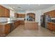 Spacious kitchen featuring a large island, stainless steel appliances, and tile flooring at 16112 W Durango St, Goodyear, AZ 85338