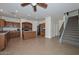 Open-concept kitchen featuring wooden cabinets, a center island, and adjacent staircase at 16112 W Durango St, Goodyear, AZ 85338