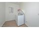 Bright laundry room with a washing machine, dryer and shelving at 16112 W Durango St, Goodyear, AZ 85338