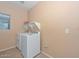 Functional laundry room with washer, dryer, and storage shelf at 16112 W Durango St, Goodyear, AZ 85338