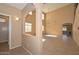 View of the main living area with an arched entry, soaring ceilings, and tile flooring and natural light at 16112 W Durango St, Goodyear, AZ 85338