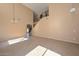 Spacious living room featuring a staircase, tile floors and neutral colored walls at 16112 W Durango St, Goodyear, AZ 85338