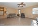 Open-concept living room with tile flooring and comfortable seating arrangement at 16112 W Durango St, Goodyear, AZ 85338