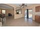 View of the living room and kitchen area with tile flooring and open floor plan at 16112 W Durango St, Goodyear, AZ 85338